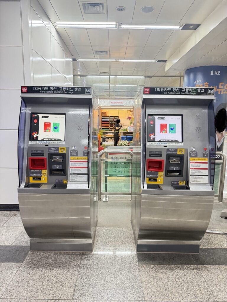 Two fare and transit card recharge machines at a Seoul subway station entrance