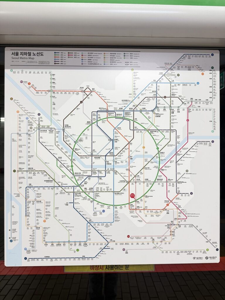 Printed Seoul subway map posted inside a station with a you-are-here marker