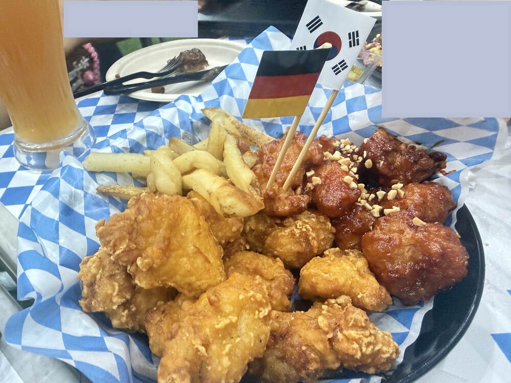 Korean fried chicken and fries with small German and Korean flags on toothpicks at Oktoberfest Seoul