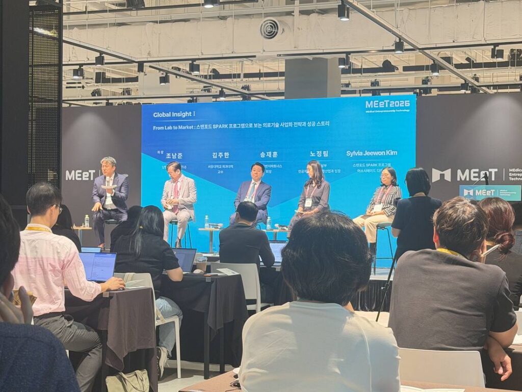 Panel discussion at MEeT 2026 titled Global Insight I, From Lab to Market, featuring five panelists on stage with Stanford SPARK branding